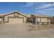 Beige house with two-car garage, landscaping, and a real estate sign at 14426 W Morning Star Trl, Surprise, AZ 85374
