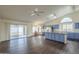 Open kitchen boasts an island, blue cabinets, and access to backyard at 14426 W Morning Star Trl, Surprise, AZ 85374