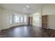 Bright living room with hardwood floors, built-in shelves, and large windows at 14426 W Morning Star Trl, Surprise, AZ 85374