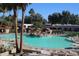 Community swimming pool with waterfall feature and ample lounge chairs at 14426 W Morning Star Trl, Surprise, AZ 85374