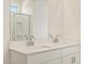 Bathroom featuring double sinks and a shower with glass door at 16023 W Desert Hollow Dr, Surprise, AZ 85387