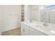 Bathroom showcasing double sinks, white cabinetry, and glass enclosed shower at 16023 W Desert Hollow Dr, Surprise, AZ 85387