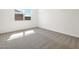 Neutral bedroom offers bright, natural light and neutral carpeting at 16023 W Desert Hollow Dr, Surprise, AZ 85387