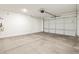 Spacious garage with concrete floors and an automatic door, ready for parking and storage at 16023 W Desert Hollow Dr, Surprise, AZ 85387