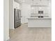 Kitchen with white cabinets, stainless steel appliances, and island with pendant lighting at 16023 W Desert Hollow Dr, Surprise, AZ 85387