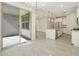 Open floorplan featuring tile flooring, modern chandelier and stainless steel appliances at 16023 W Desert Hollow Dr, Surprise, AZ 85387