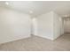 Open living room area with tile floors and neutral wall color at 16023 W Desert Hollow Dr, Surprise, AZ 85387