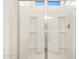 Shower features glass doors and built-in shelving at 16023 W Desert Hollow Dr, Surprise, AZ 85387
