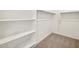 Walk-in closet features built-in shelving and rod at 16023 W Desert Hollow Dr, Surprise, AZ 85387