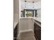 Modern bar area with quartz countertops, wine fridge, and backyard view at 2835 E Los Gatos Dr, Phoenix, AZ 85050