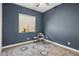 Cozy bedroom with blue accent wall, window with privacy and natural light at 2835 E Los Gatos Dr, Phoenix, AZ 85050