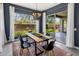 Elegant dining room with a modern table, stylish chairs, and a large window with backyard views at 2835 E Los Gatos Dr, Phoenix, AZ 85050