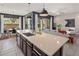 Open kitchen with a large island, stylish pendant lighting, and seamless connection to the dining and living areas at 2835 E Los Gatos Dr, Phoenix, AZ 85050