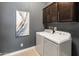 Functional laundry room with washer, dryer, storage cabinets, and artwork at 2835 E Los Gatos Dr, Phoenix, AZ 85050