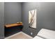 Gray walled Laundry Room with Tile Floor, Wooden Shelf, Artwork, and White Washer/Dryer at 2835 E Los Gatos Dr, Phoenix, AZ 85050