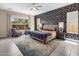 Spacious main bedroom with decorative wallpaper, ceiling fan, and outside view at 2835 E Los Gatos Dr, Phoenix, AZ 85050