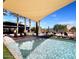 Community pool featuring a covered seating area, lounge chairs, fountains, and palm trees at 2835 E Los Gatos Dr, Phoenix, AZ 85050
