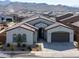 Exterior view of a single-story house with a tile roof and two-car garage at 3919 W Hayduk Rd, Laveen, AZ 85339