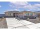 Charming single-story home featuring stone accents, a tile roof, and a spacious driveway leading to an attached garage at 4079 N Ghost Hollow Way, Casa Grande, AZ 85122