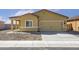 Home exterior showing the garage and a low-maintenance gravel front yard with sidewalk at 659 W Pintail Dr, Casa Grande, AZ 85122