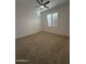 Well-lit bedroom featuring carpet and window shutters at 8724 E Nopal Cir, Mesa, AZ 85209