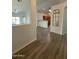 View of the kitchen and living area from the entryway with wood-look floors at 8724 E Nopal Cir, Mesa, AZ 85209