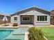 Private backyard oasis with a refreshing pool, covered patio, and verdant landscaping at 10559 E Simone Ave, Mesa, AZ 85212