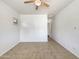 Bright bedroom includes a ceiling fan, neutral walls, and tiled floor at 10559 E Simone Ave, Mesa, AZ 85212