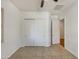 This bright bedroom features tile floors, closet with sliding doors, and a ceiling fan at 10559 E Simone Ave, Mesa, AZ 85212