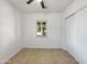 Clean and bright bedroom with tile floors, a window with shutter, and a closet at 10559 E Simone Ave, Mesa, AZ 85212