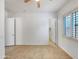 Bright, spacious bedroom with tile floors, ceiling fan and large windows at 10559 E Simone Ave, Mesa, AZ 85212