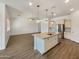 An open-concept kitchen features an island, stainless steel appliances, and plenty of cabinet space at 10559 E Simone Ave, Mesa, AZ 85212