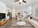 Open-concept living room showcases stylish decor with natural light and modern kitchen at 10559 E Simone Ave, Mesa, AZ 85212