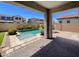 This home's backyard features a refreshing pool with privacy landscaping and a patio area at 10559 E Simone Ave, Mesa, AZ 85212