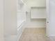 Bright walk-in closet with built in shelves and rods for organization at 10559 E Simone Ave, Mesa, AZ 85212