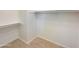 A bright walk-in closet features built-in shelving and neutral tile flooring at 10559 E Simone Ave, Mesa, AZ 85212