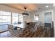 Contemporary dining room with modern light fixture, table with seating for six, and large sliding doors at 12635 N Sun Valley Dr, Sun City, AZ 85351