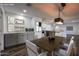 Open-concept dining area with stylish light fixture, and adjacent modern kitchen, creates a welcoming atmosphere at 12635 N Sun Valley Dr, Sun City, AZ 85351