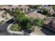 Aerial view showcases a landscaped yard and neighborhood streets at 13613 W Cypress St, Goodyear, AZ 85395
