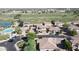 Aerial view displays homes with solar, lake, golf course, and community pool at 13613 W Cypress St, Goodyear, AZ 85395