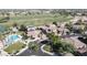 Aerial view displays homes with solar, lake, golf course, and community pool at 13613 W Cypress St, Goodyear, AZ 85395