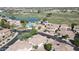 An aerial view showcases a community with a pool, lake, golf course, and well-maintained landscaping at 13613 W Cypress St, Goodyear, AZ 85395