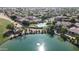 Aerial view showing the lake, golf course, community pool, and homes at 13613 W Cypress St, Goodyear, AZ 85395