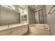 Bathroom with double vanity, large tub and block window at 13613 W Cypress St, Goodyear, AZ 85395