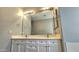 Double vanity bathroom with a large mirror and updated fixtures at 13613 W Cypress St, Goodyear, AZ 85395