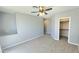 Bedroom with a ceiling fan, closet and neutral colored carpet at 13613 W Cypress St, Goodyear, AZ 85395