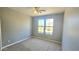 Bedroom features a ceiling fan and large window with outdoor views at 13613 W Cypress St, Goodyear, AZ 85395