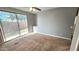 Spacious bedroom with carpet flooring and sliding glass door to backyard at 13613 W Cypress St, Goodyear, AZ 85395