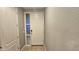 Light gray entryway with tiled floor and white door at 13613 W Cypress St, Goodyear, AZ 85395