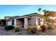Tan colored stucco house with stone accents and a landscaped yard at 13613 W Cypress St, Goodyear, AZ 85395